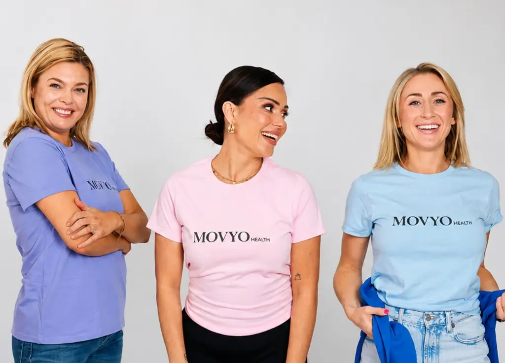 Three Movyo Health community members smiling in branded t-shirts